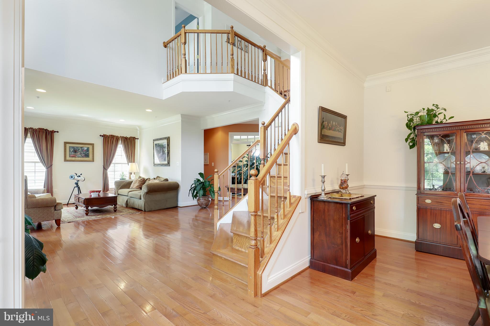 6905 Ironbridge Lane Laurel, MD 20707 - Photo 3 of 30 a living room with furniture a flat screen tv and a large window