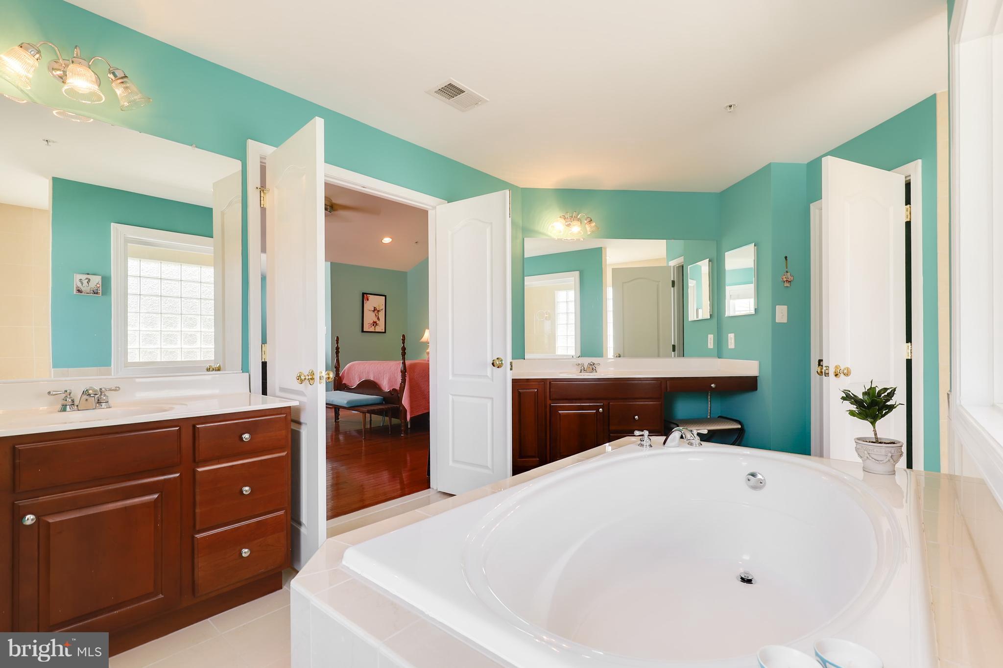 6905 Ironbridge Lane Laurel, MD 20707 - Photo 21 of 30 a spacious bathroom with a tub sink and mirror