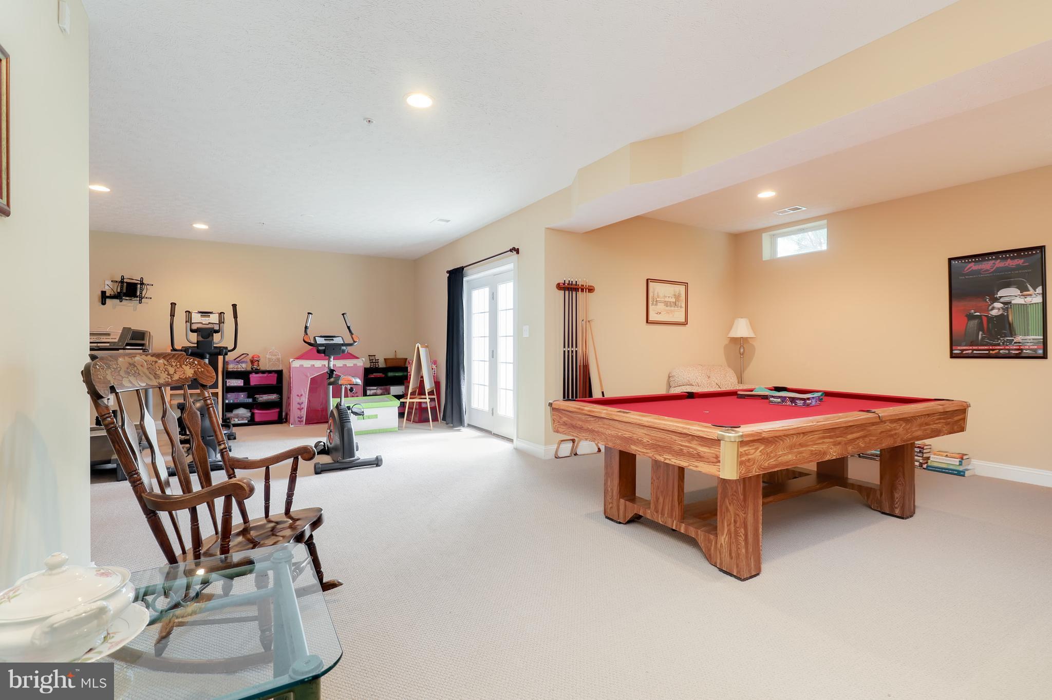 6905 Ironbridge Lane Laurel, MD 20707 - Photo 22 of 30 a living room with a table tennis table and chairs