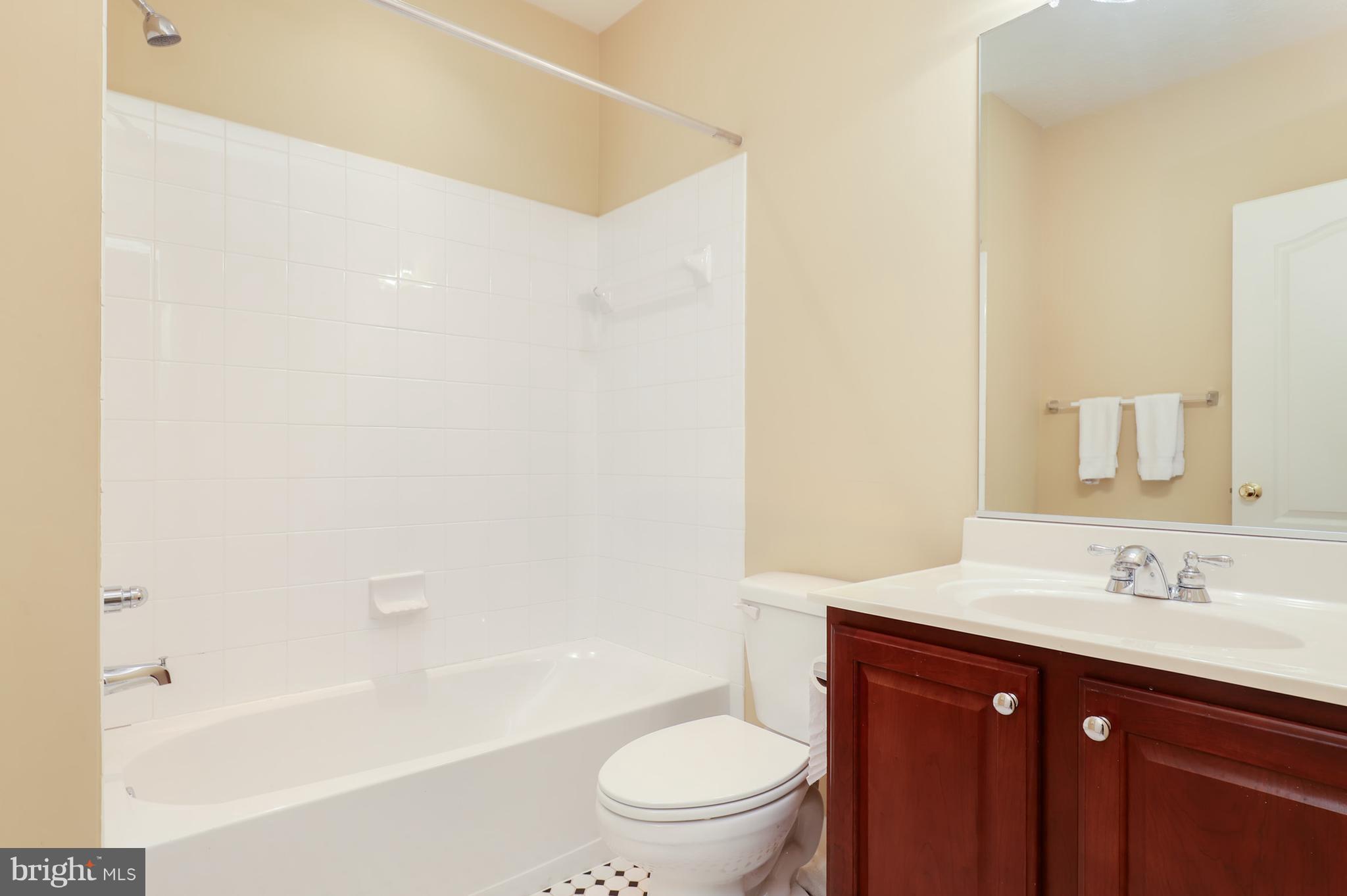 6905 Ironbridge Lane Laurel, MD 20707 - Photo 26 of 30 a bathroom with a sink a toilet and a bathtub