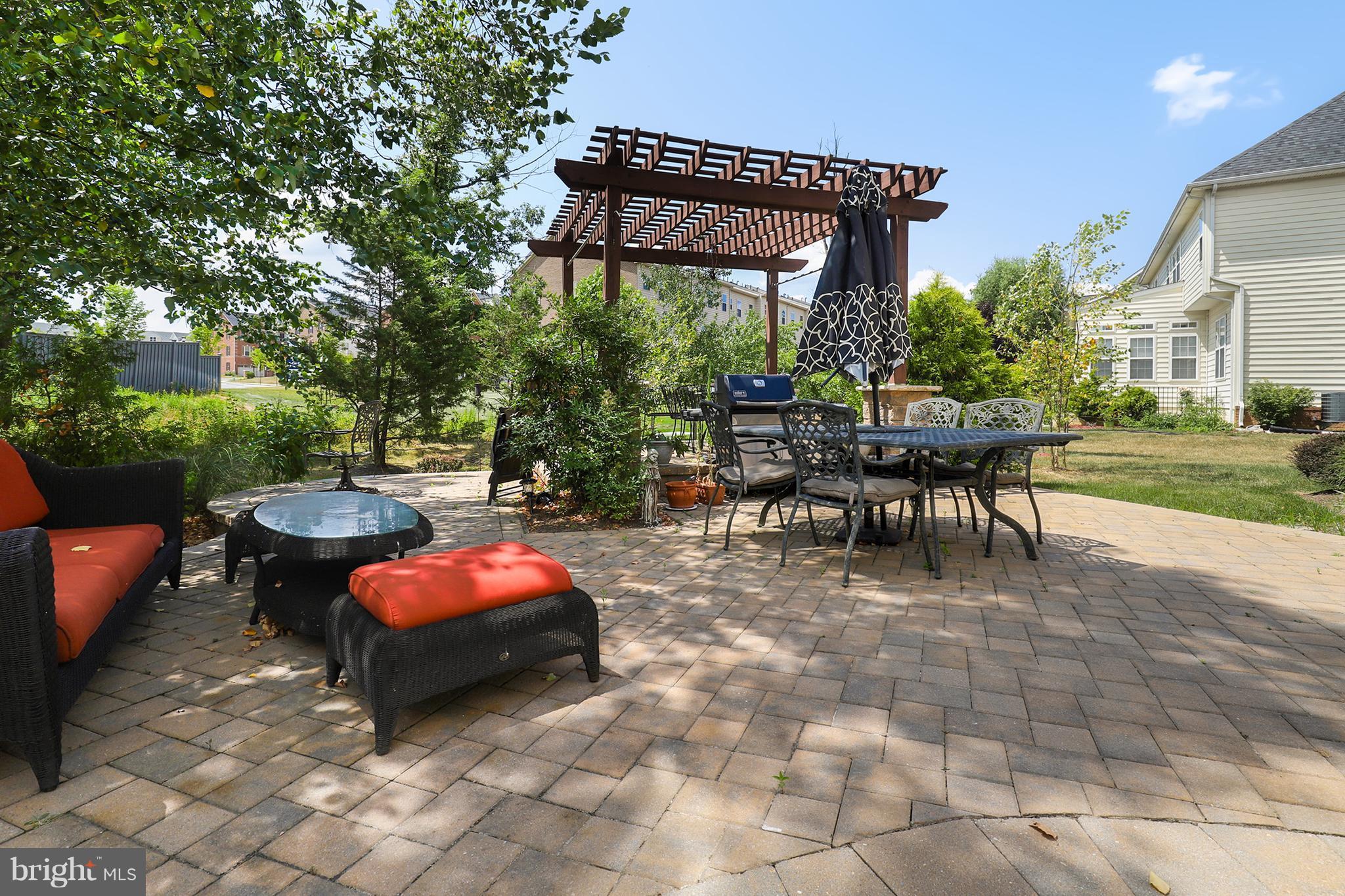 6905 Ironbridge Lane Laurel, MD 20707 - Photo 29 of 30 a patio with a table and chairs and a barbeque