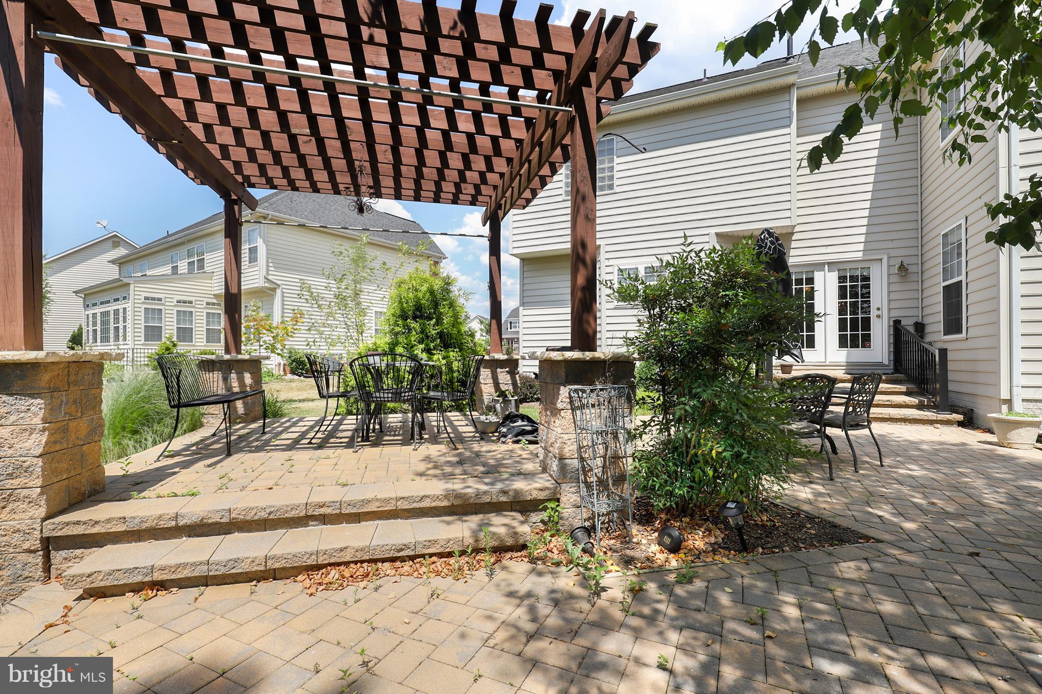 6905 Ironbridge Lane Laurel, MD 20707 - Photo 30 of 30 a view of a patio with table and chairs and potted plants