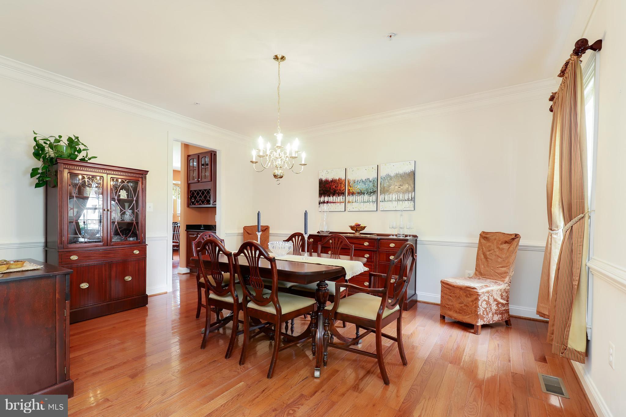 6905 Ironbridge Lane Laurel, MD 20707 - Photo 5 of 30 a view of a dining room with furniture and wooden floor