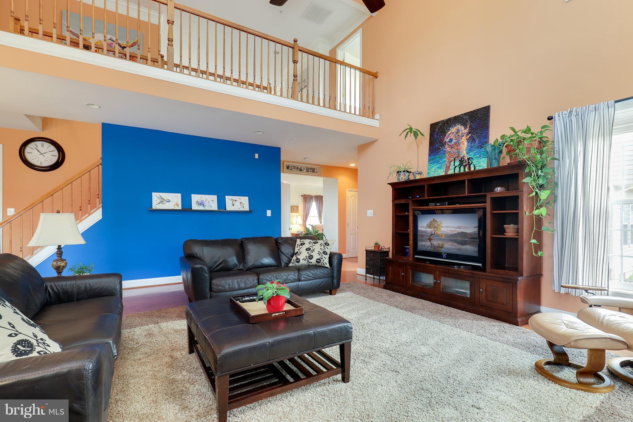 6905 Ironbridge Lane Laurel, MD 20707 - Photo 7 of 30 a living room with furniture and a flat screen tv