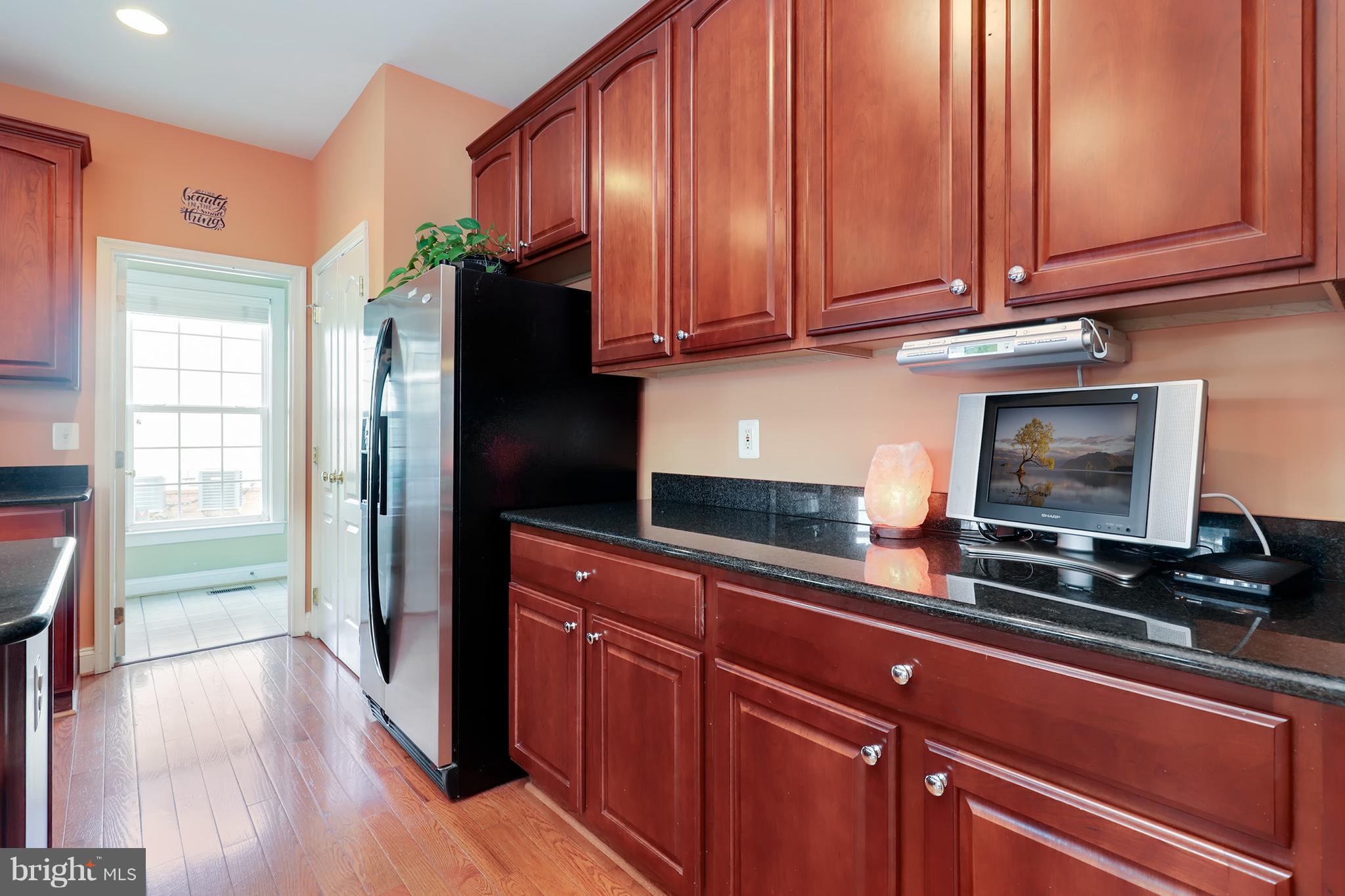 6905 Ironbridge Lane Laurel, MD 20707 - Photo 10 of 30 a kitchen with stainless steel appliances granite countertop a refrigerator and a stove top oven