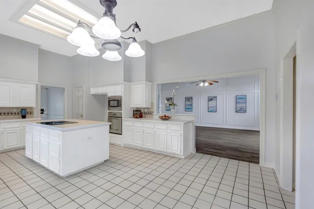 a large white kitchen with cabinets