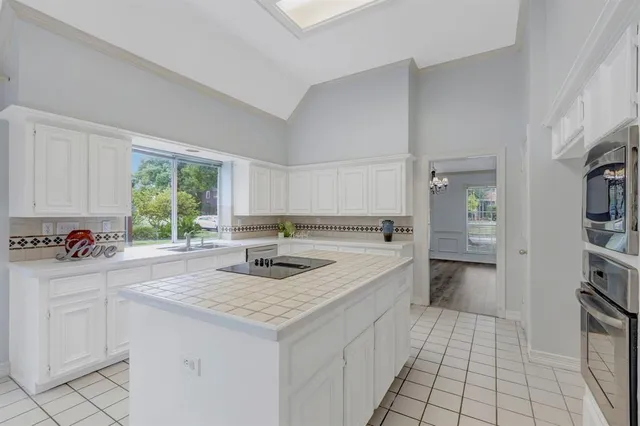 a kitchen with a sink cabinets and window