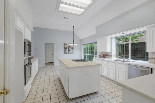 a kitchen with a sink stove and cabinets