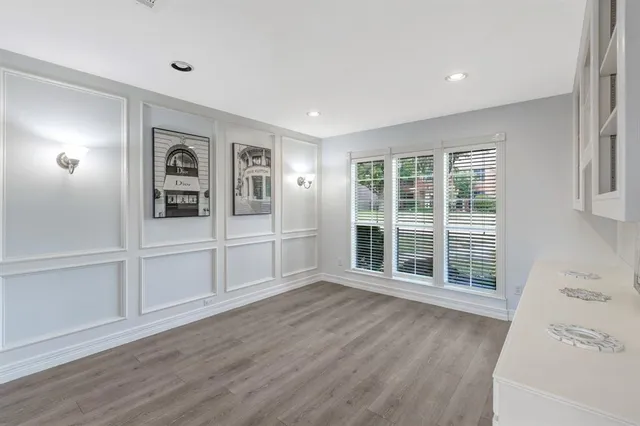 a view of a livingroom with wooden floor and white walls