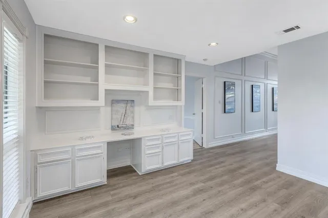 a view of cabinets and wooden floor