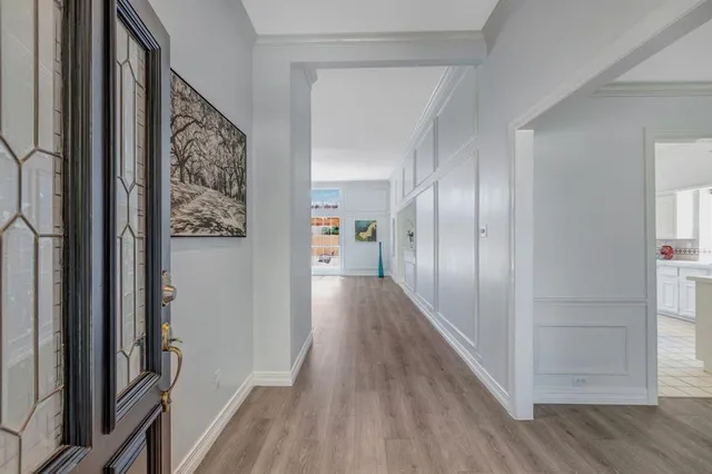 a view of hallway with wooden floor