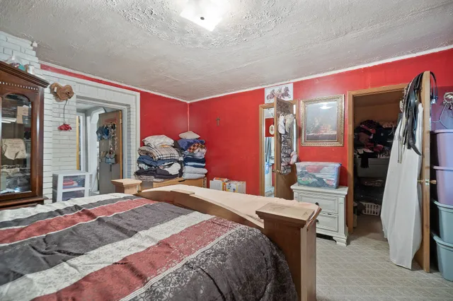 a bedroom with a bed dresser and a large mirror