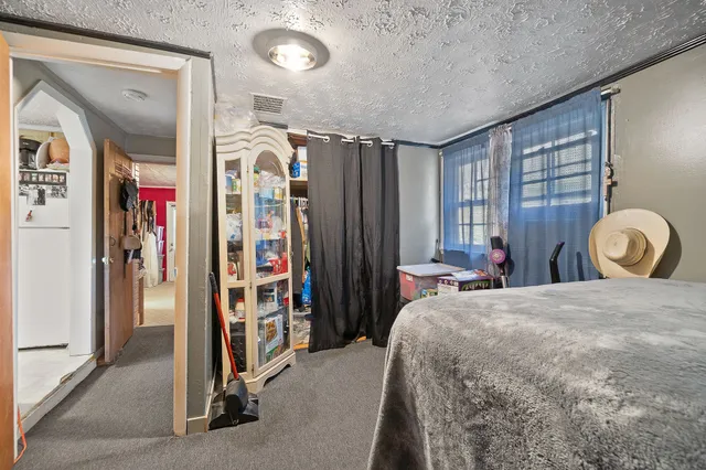 a bedroom with a bed and a large mirror