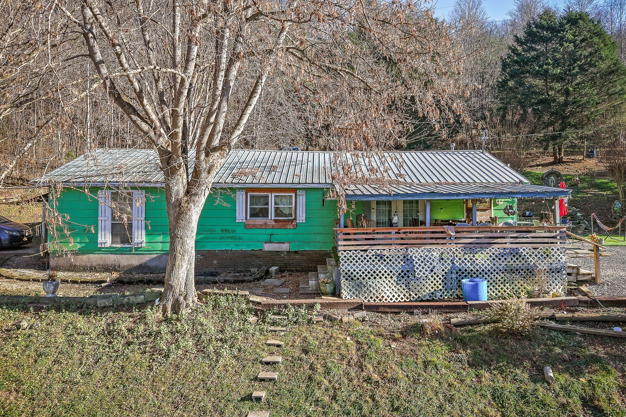 2184 Hyder Mountain Road Cookeville, TN 38506 - Photo 2 of 33 a front view of a house with a garden and tree