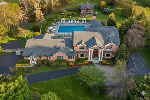 an aerial view of residential houses with outdoor space and street view