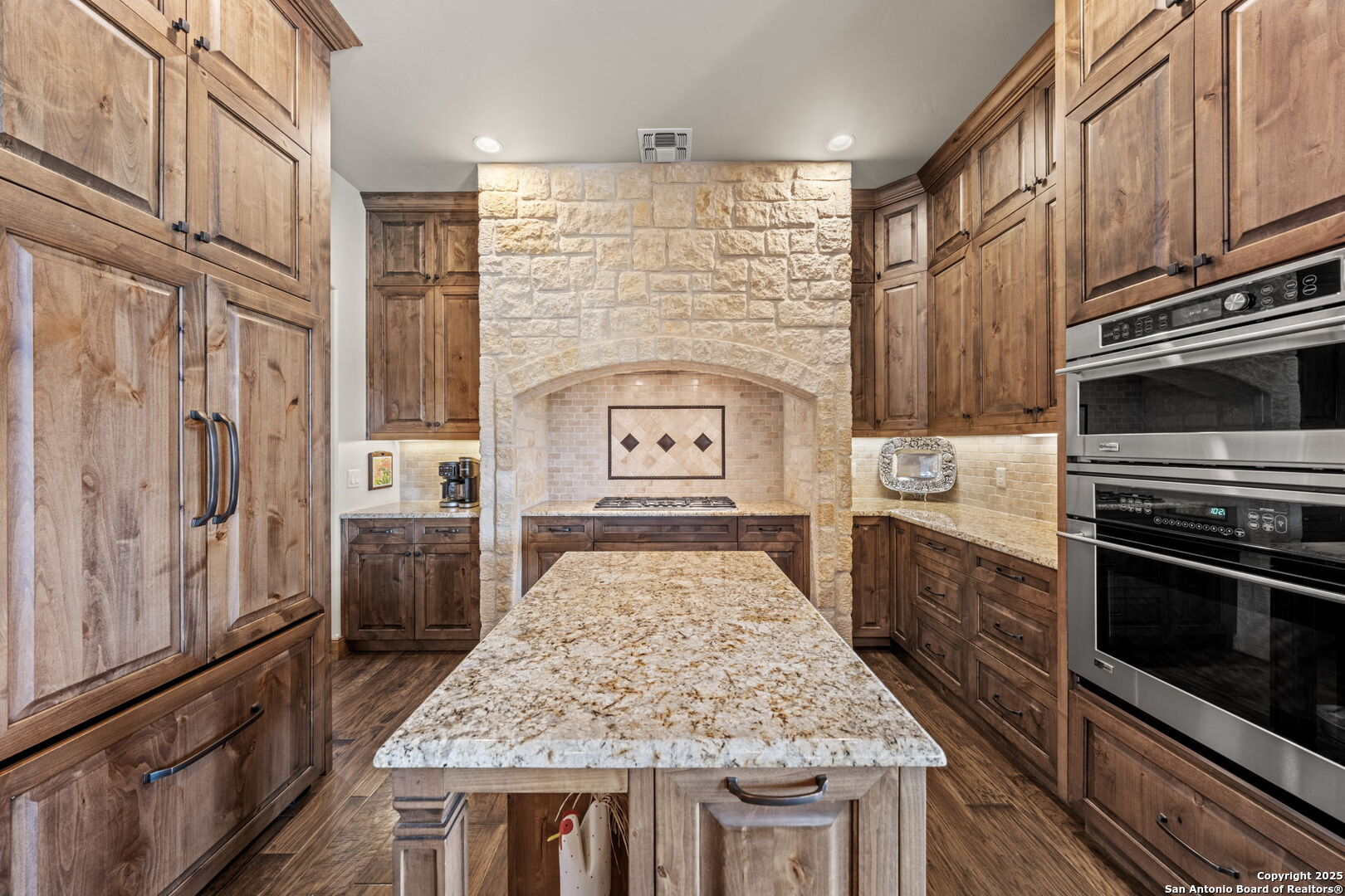 131 Bootlegger Lane North Kerrville, TX 78028 - Photo 15 of 50 a kitchen with stainless steel appliances granite countertop a stove a sink and a refrigerator
