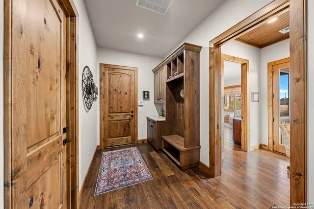 a bathroom with a granite countertop toilet and a sink