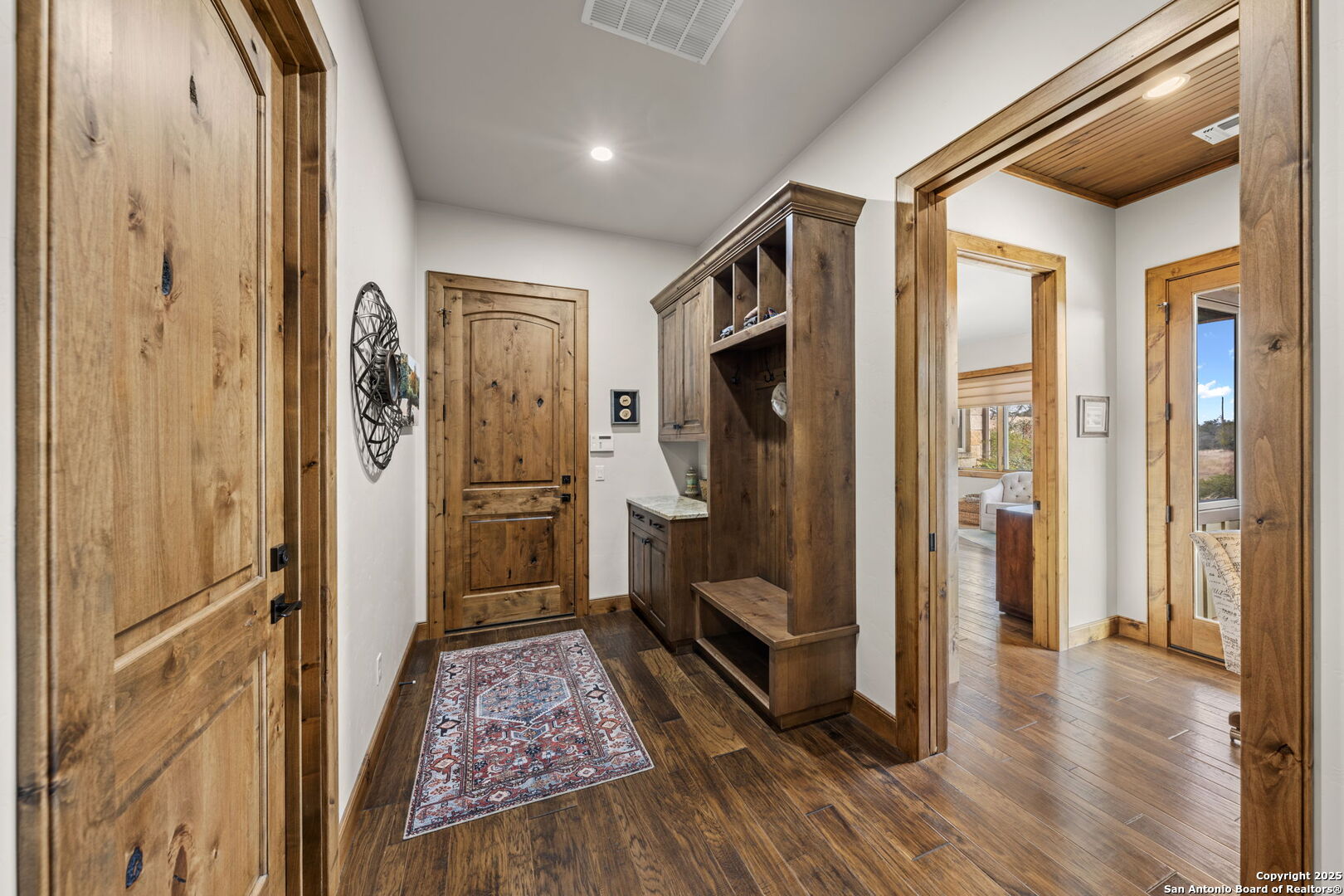 131 Bootlegger Lane North Kerrville, TX 78028 - Photo 24 of 50 a view of a hallway with wooden floor and a bathroom