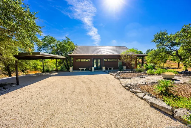 a living room with furniture a large window and a fireplace