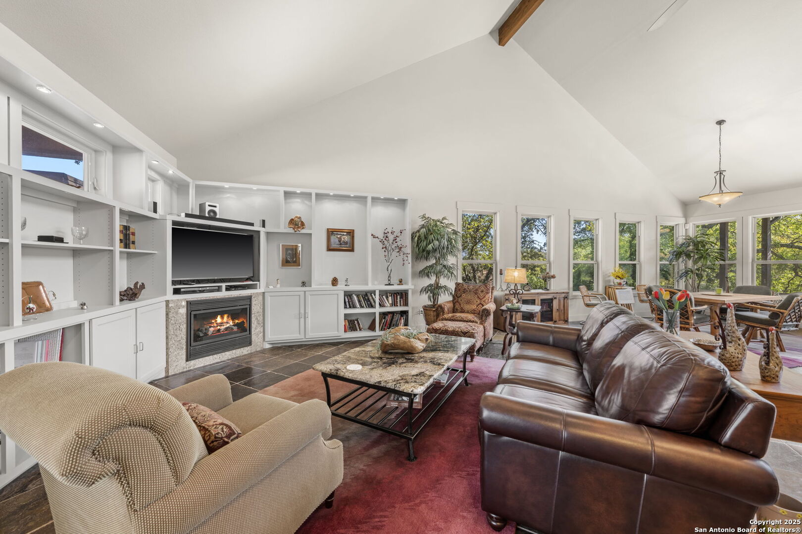 131 Bootlegger Lane North Kerrville, TX 78028 - Photo 35 of 50 a living room with furniture a large window and a fireplace