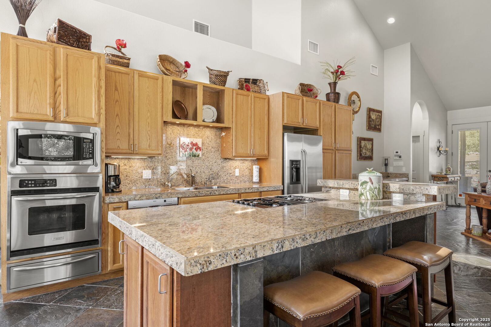 131 Bootlegger Lane North Kerrville, TX 78028 - Photo 36 of 50 a kitchen with granite countertop a sink chairs and cabinets