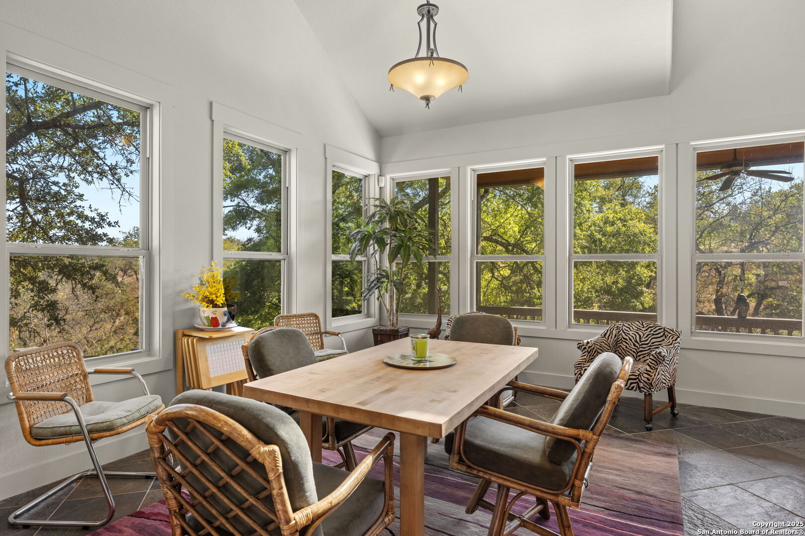 131 Bootlegger Lane North Kerrville, TX 78028 - Photo 38 of 50 a view of a dining room with furniture large windows and wooden floor