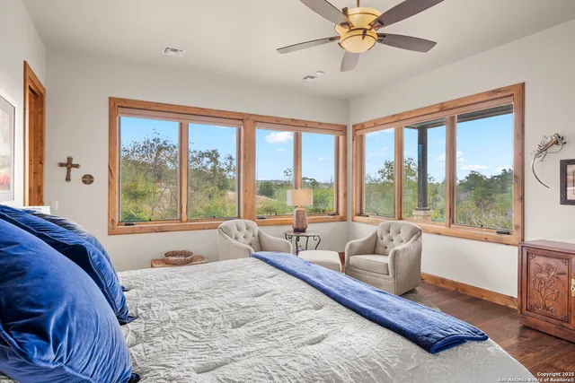 a spacious bedroom with a bed and glass walk in closet