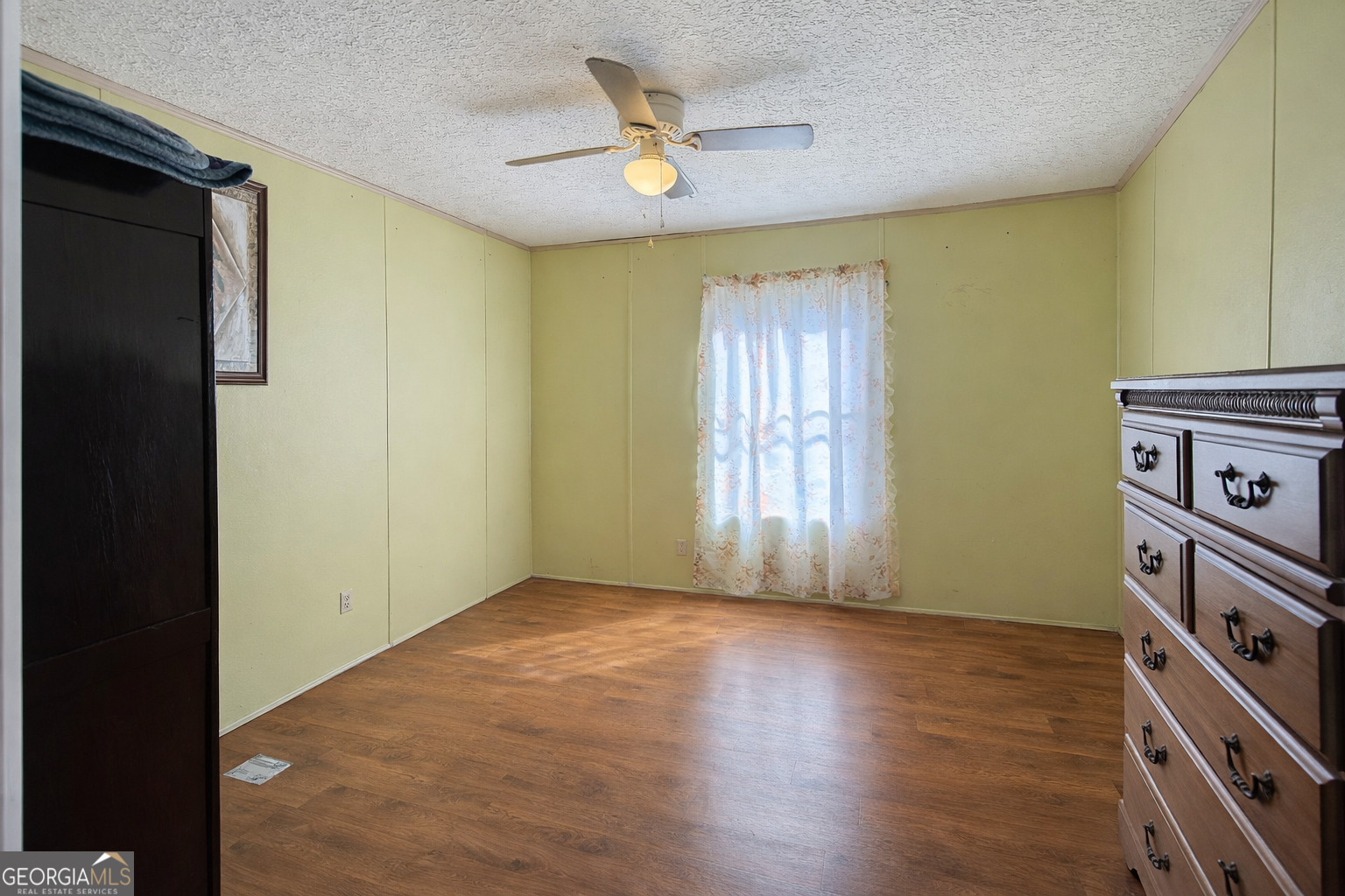 459 Louie Hightower Road Collins, GA 30421 - Photo 8 of 22 a view of an empty room with a window and wooden floor