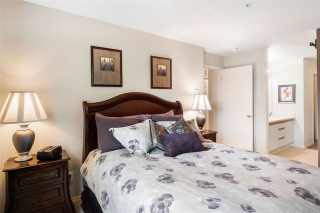 a bedroom with a bed and a lamp