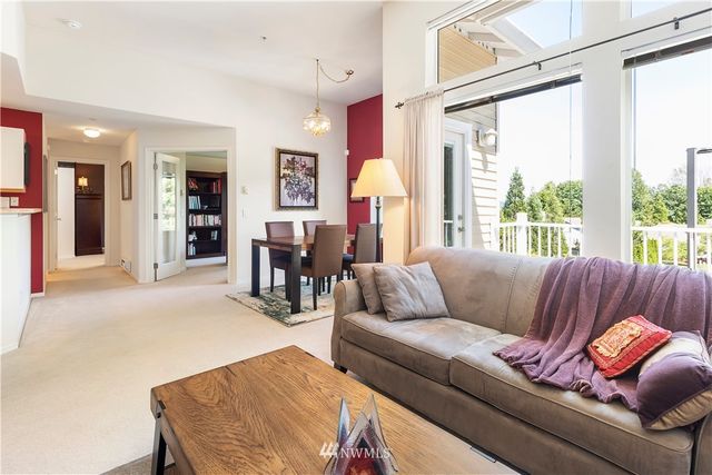a living room with furniture and large windows