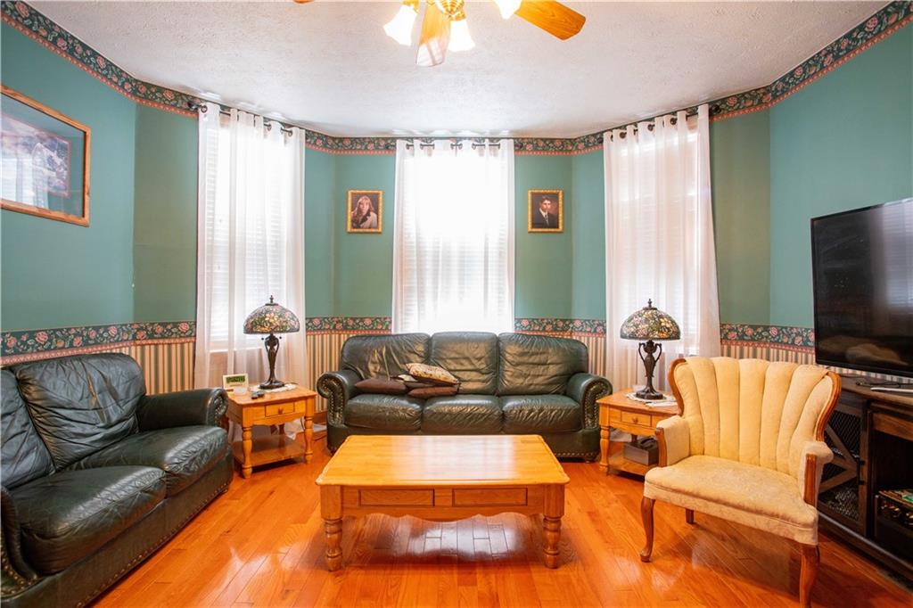 166 Pennsylvania Avenue Rochester, PA 15074 - Photo 6 of 30 a living room with furniture and a flat screen tv