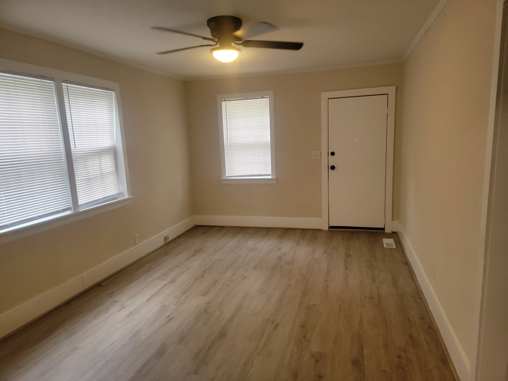 5214 Armour Road Columbus, GA 31904 - Photo 2 of 17 a view of an empty room with wooden floor and a window
