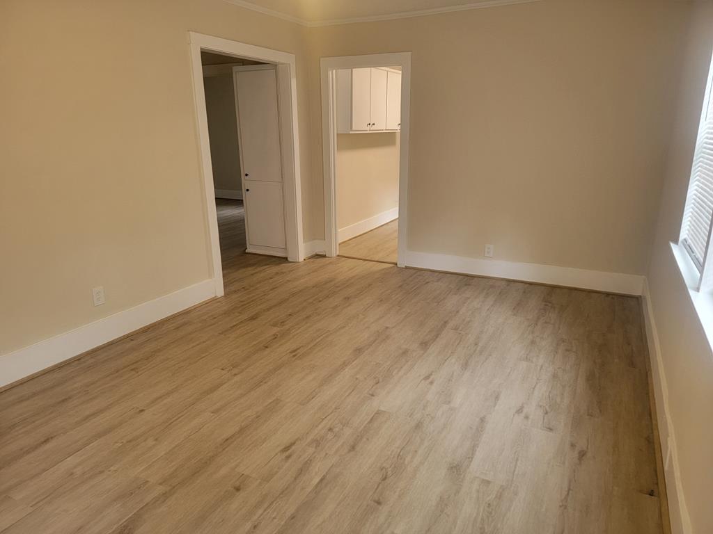 5214 Armour Road Columbus, GA 31904 - Photo 3 of 17 a view of an empty room with wooden floor and a window
