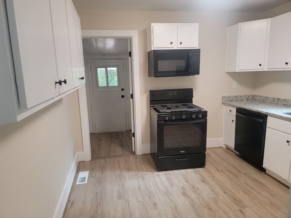 5214 Armour Road Columbus, GA 31904 - Photo 4 of 17 a kitchen with granite countertop a stove and a refrigerator