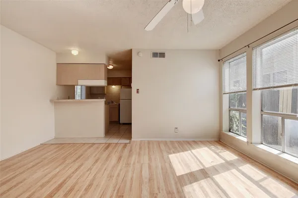 a view of wooden floor and windows in a room