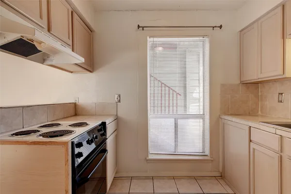 a kitchen with stainless steel appliances granite countertop a stove and a refrigerator