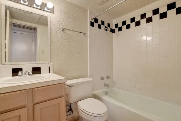 a white toilet sitting next to a bathroom sink
