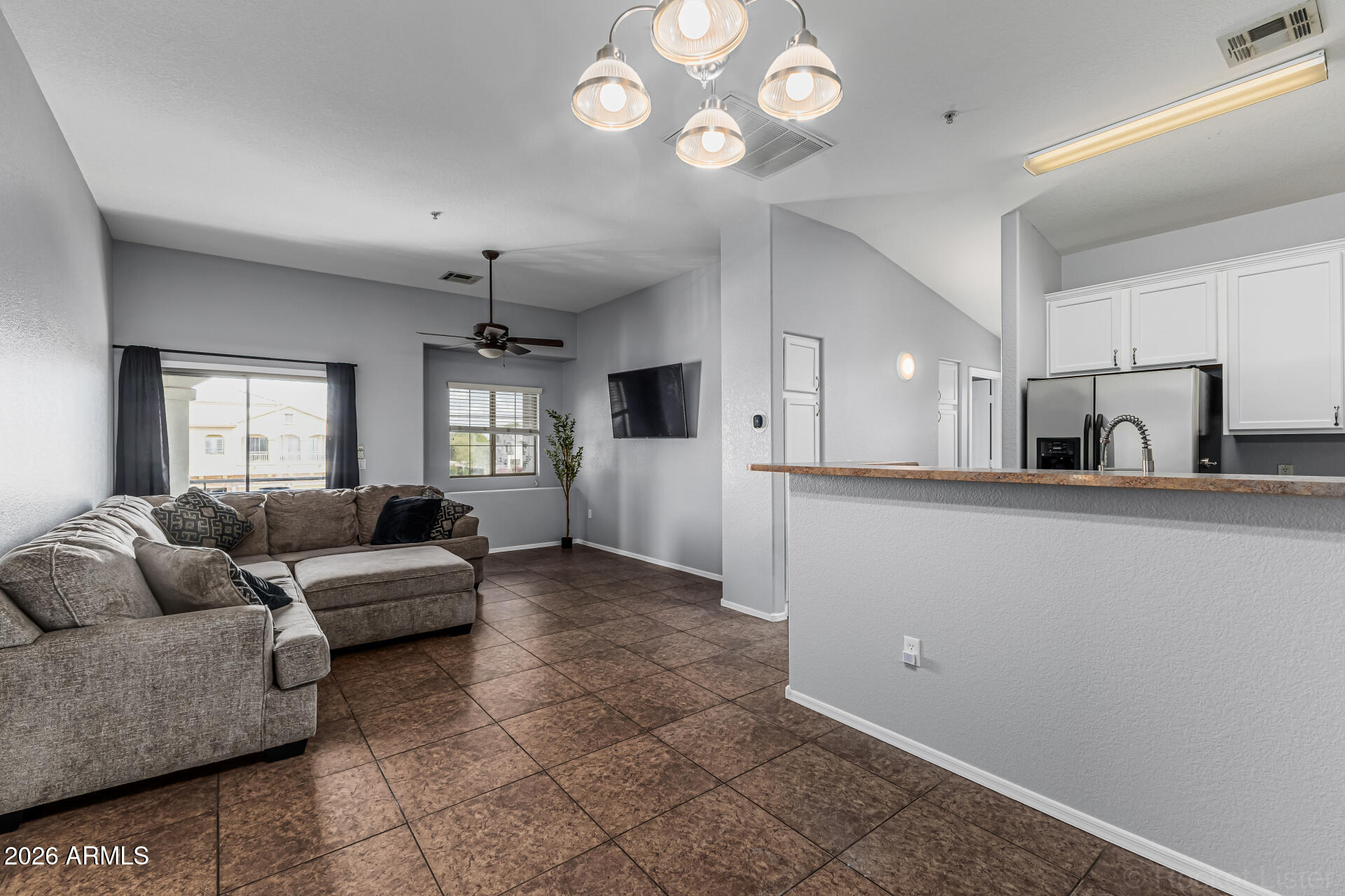 462 North 168th Lane Goodyear, AZ 85338 - Photo 2 of 32 a living room with furniture and a wooden floor