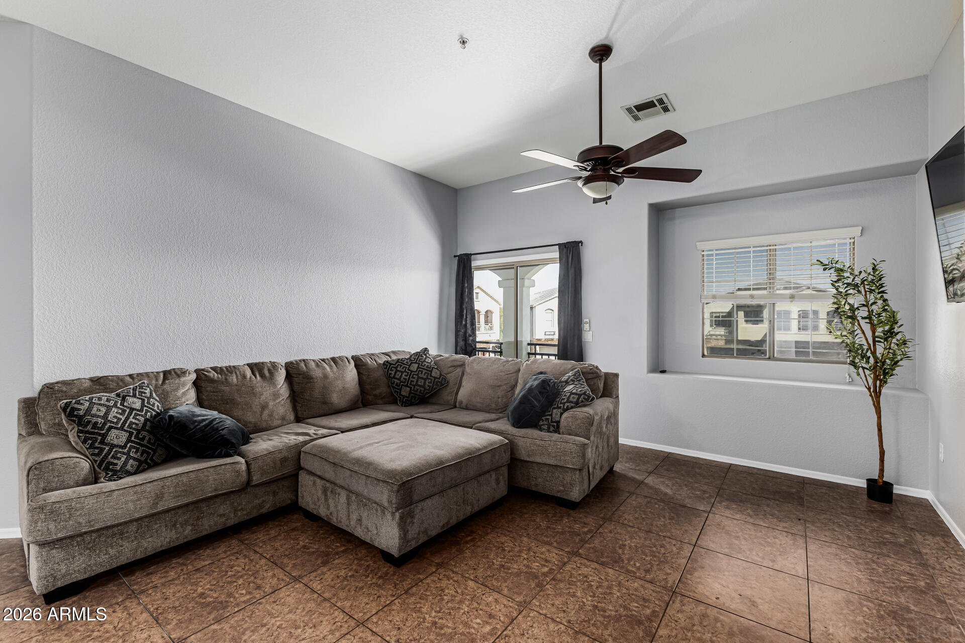 462 North 168th Lane Goodyear, AZ 85338 - Photo 3 of 32 a living room with furniture and a window