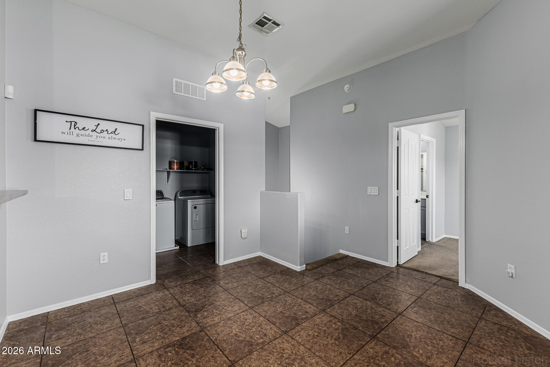 462 North 168th Lane Goodyear, AZ 85338 - Photo 5 of 32 a view of a hallway with a chandelier