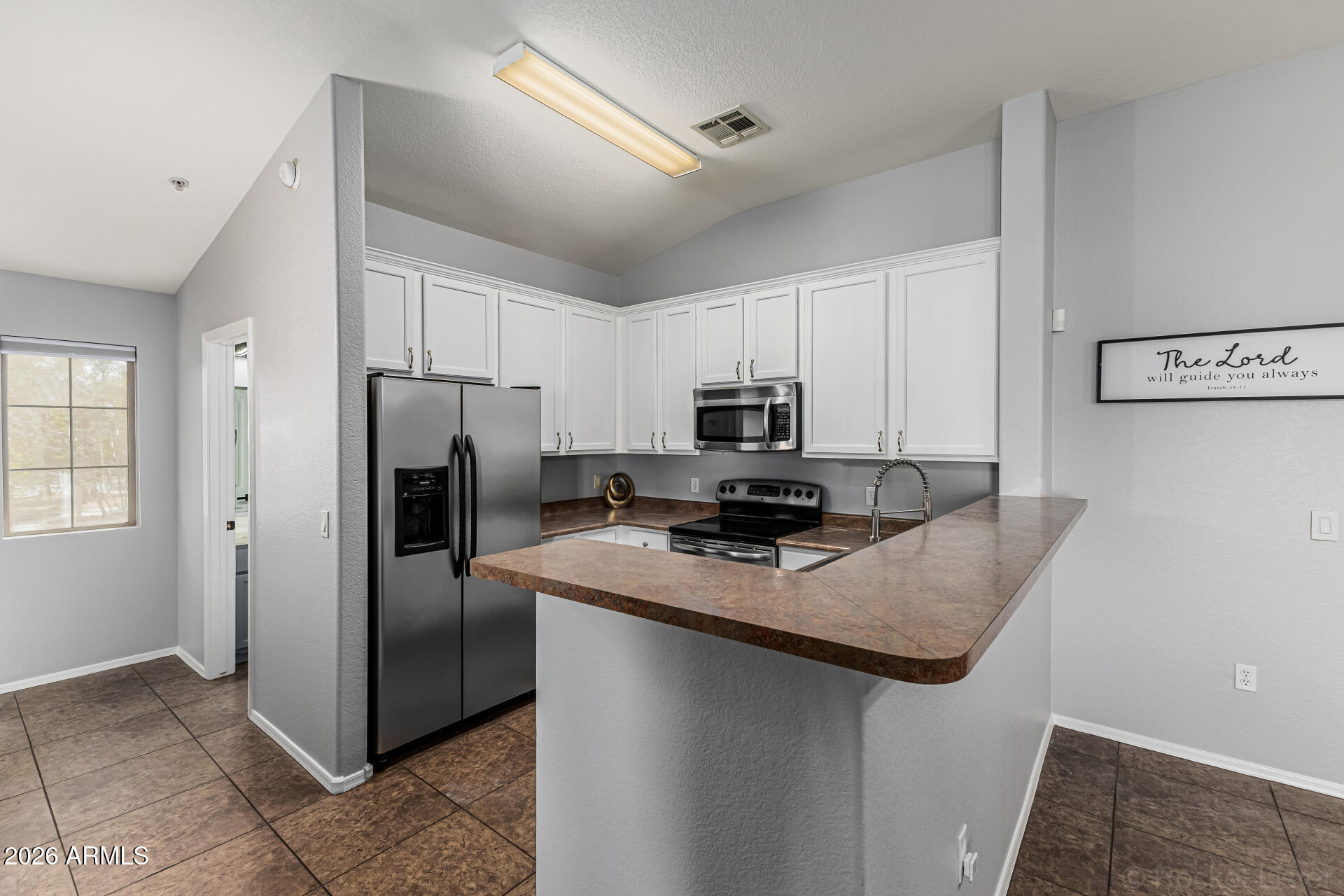 462 North 168th Lane Goodyear, AZ 85338 - Photo 6 of 32 a kitchen with stainless steel appliances a refrigerator stove microwave and sink