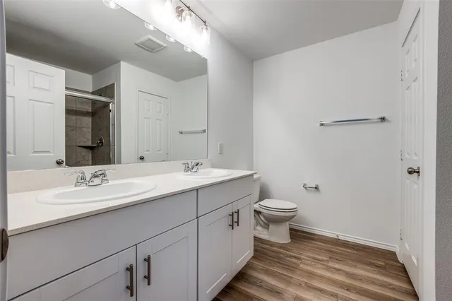 a bathroom with a double vanity sink and mirror
