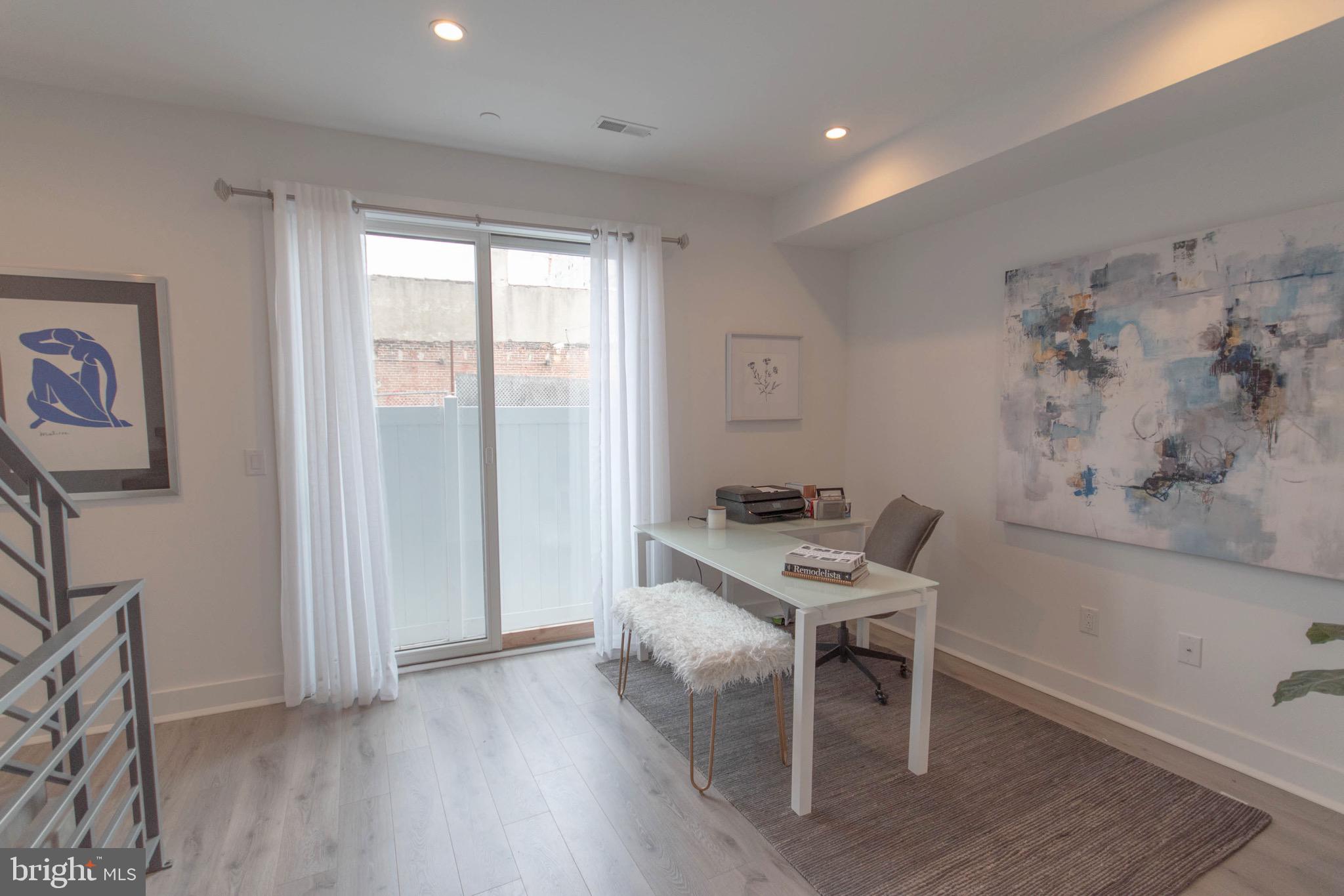 105 Olive Street Philadelphia, PA 19123 - Photo 2 of 36 a workspace with furniture and wooden floor