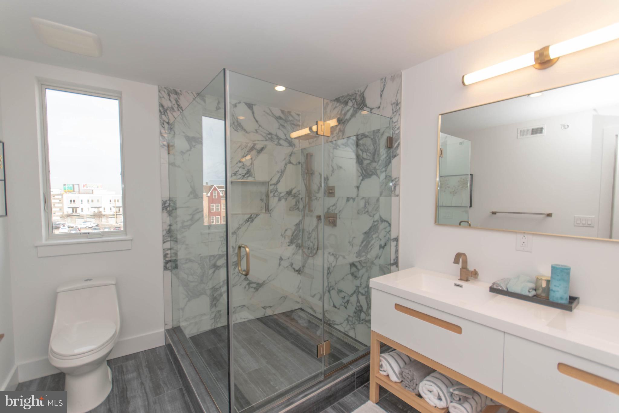 105 Olive Street Philadelphia, PA 19123 - Photo 22 of 36 a bathroom with a sink a toilet and shower