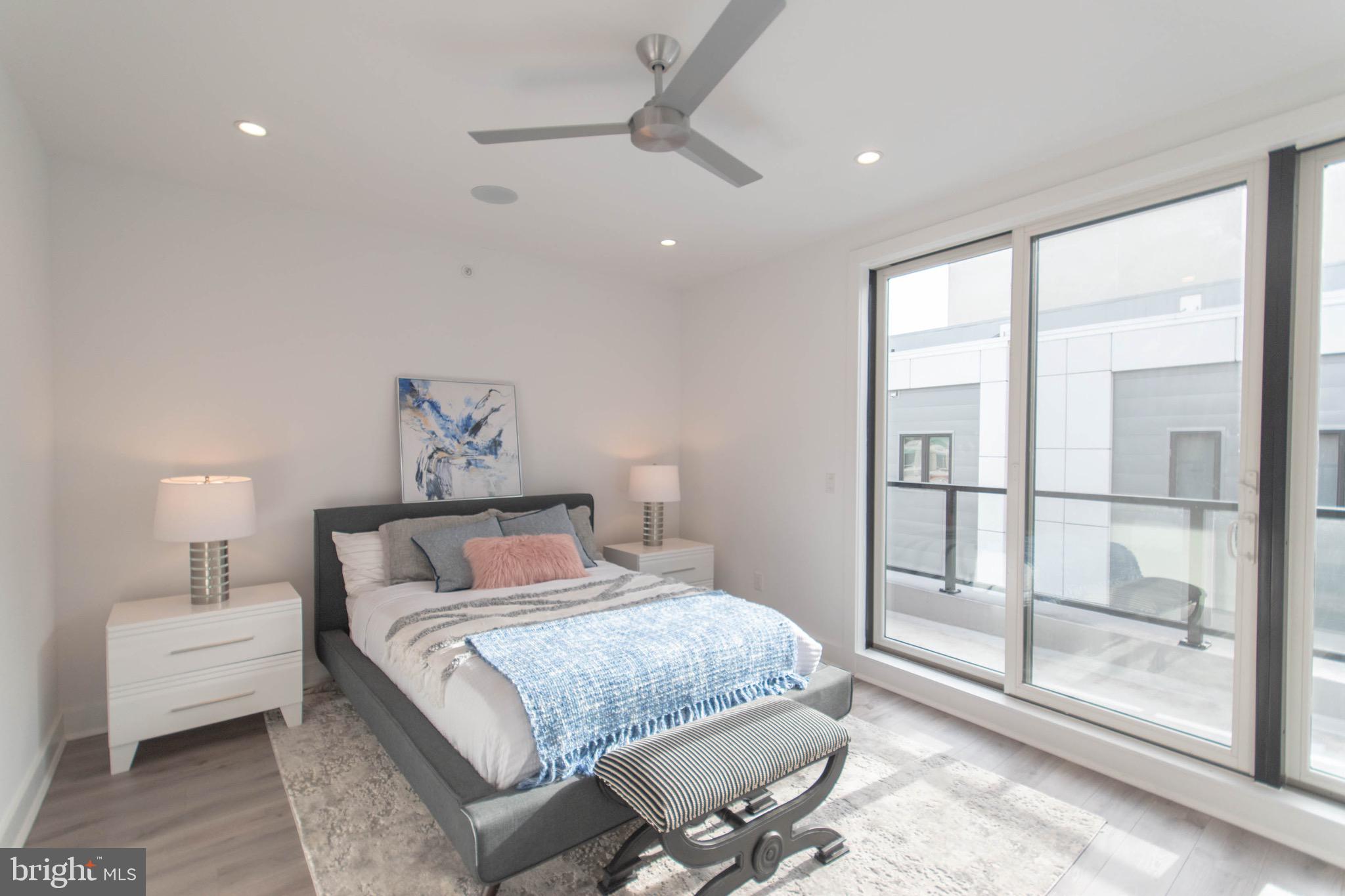 105 Olive Street Philadelphia, PA 19123 - Photo 25 of 36 a bedroom with a large bed and a night stand
