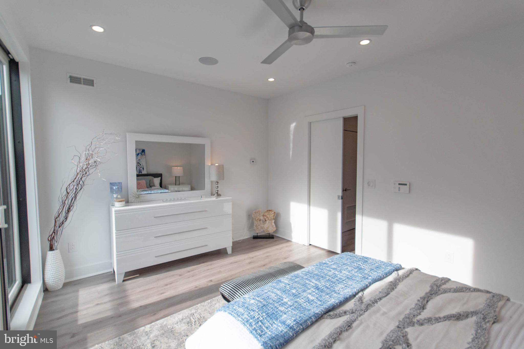 105 Olive Street Philadelphia, PA 19123 - Photo 26 of 36 a room with a bed and a mirror