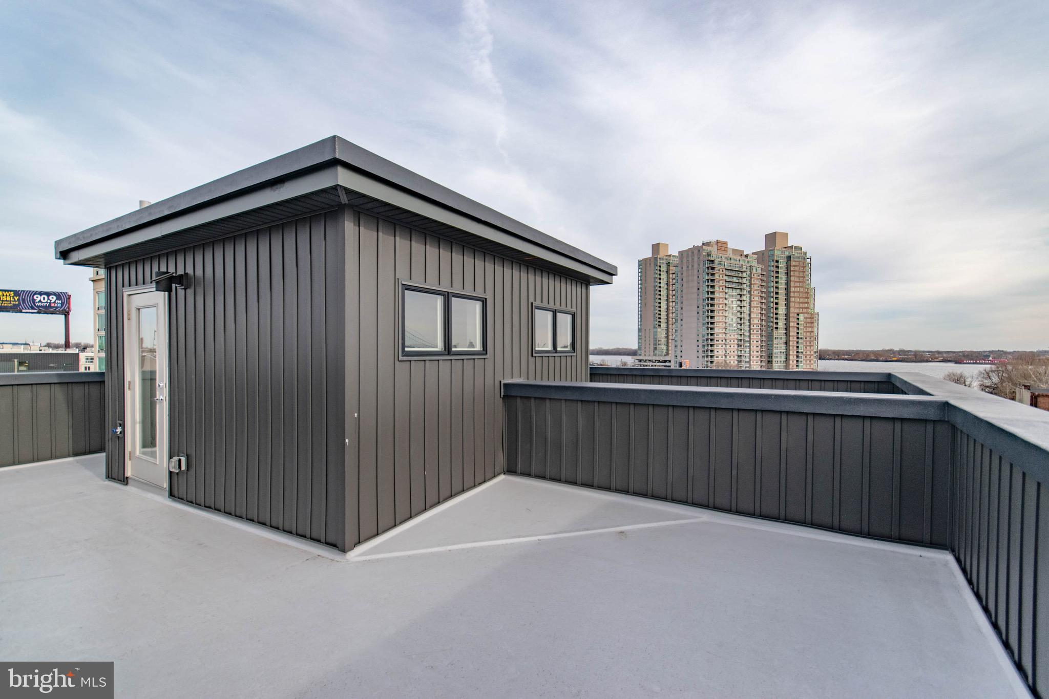 105 Olive Street Philadelphia, PA 19123 - Photo 32 of 36 a view of a roof deck with wooden fence