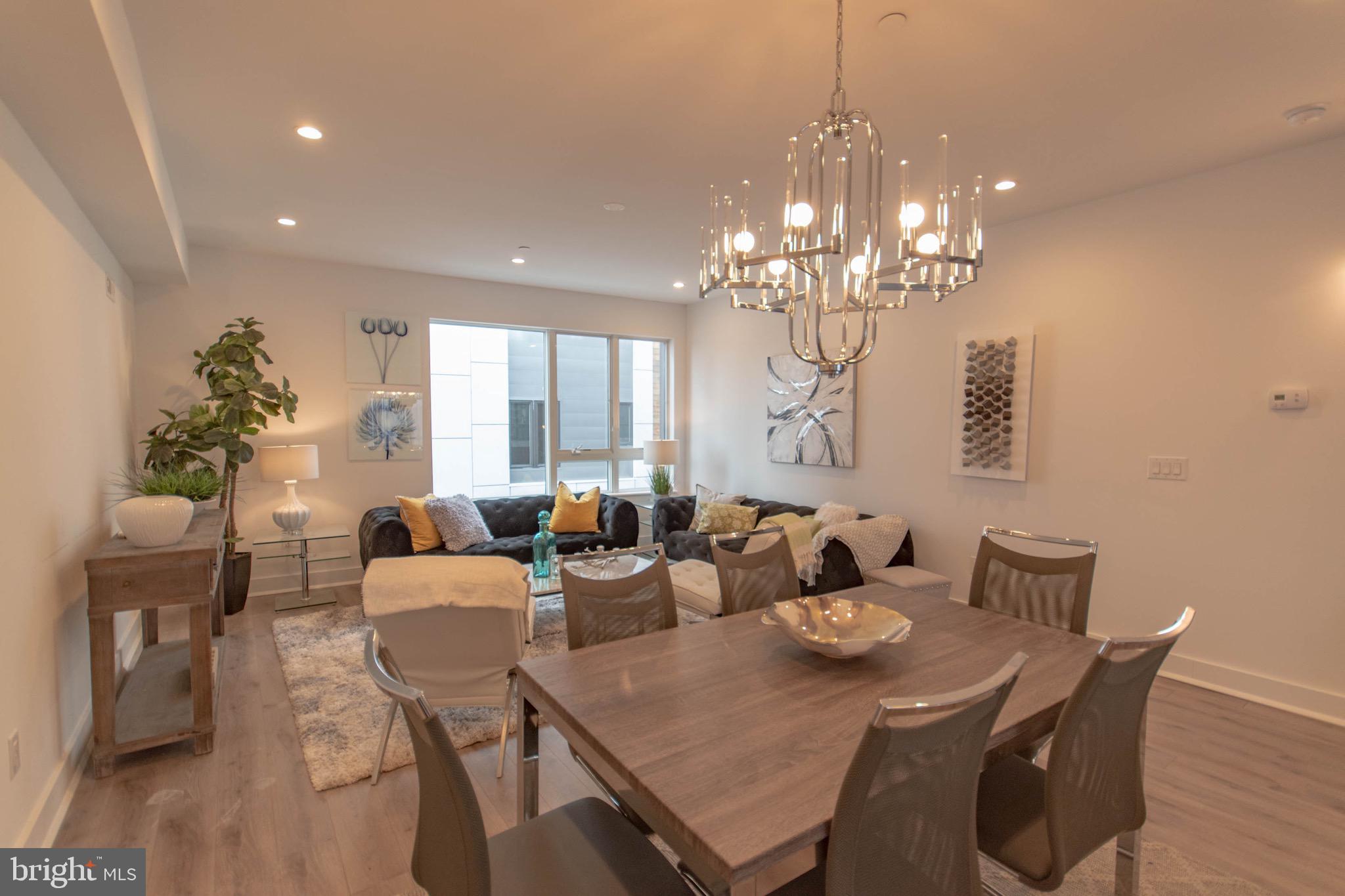 105 Olive Street Philadelphia, PA 19123 - Photo 6 of 36 a view of a dining room with furniture a chandelier and wooden floor