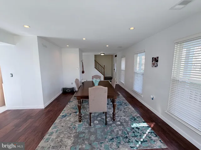 a view of a living room with furniture and wooden floor