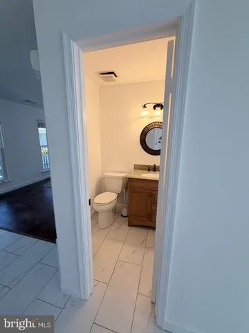 a bedroom with a bed and a flat tv screen on dresser